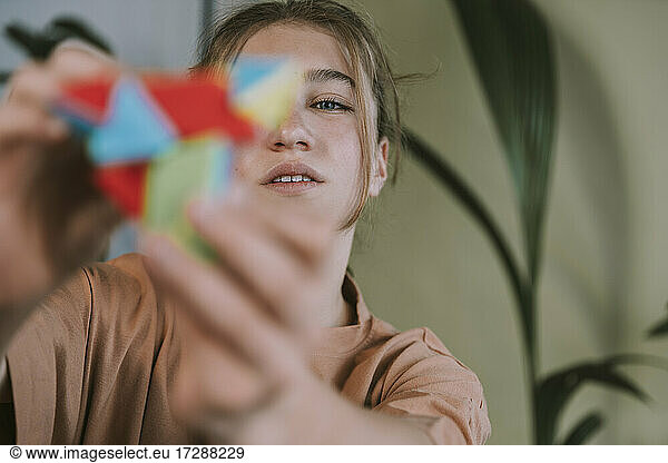 Teenage girl playing with puzzle at home