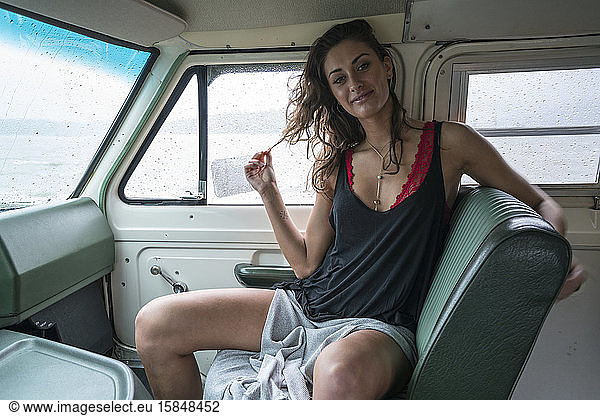 Teenage girl posing in the front seat of a van