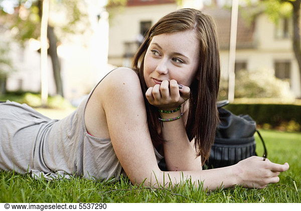 Teenage girl relaxing on garden
