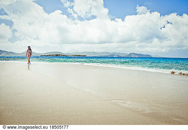 Teenage girl strolling on the beach.