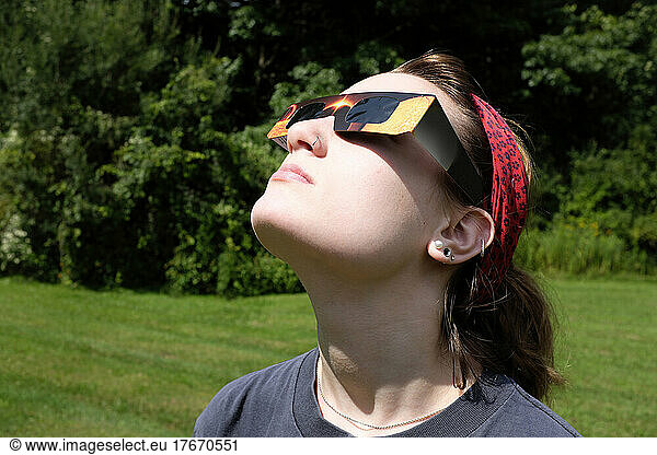 Teenage Girl wearing Eclipse Glasses while viewing Partial Solar Eclipse