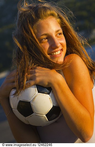 Teenage girl with handball ball outside