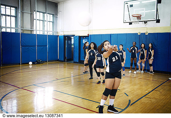 Teenage girls playing at volleyball court
