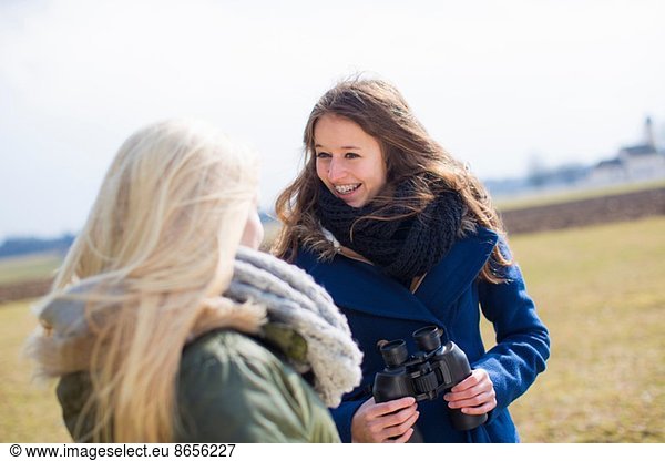 Teenage girls with binoculars