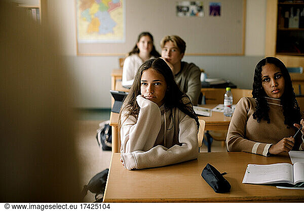 Teenage students looking with concentration in classroom