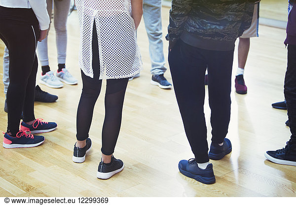 Teenage students standing in circle in dance class studio