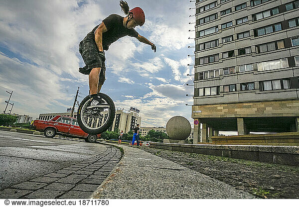 Teenager Performing Stunt With Unicycles At The Street Of Saint Petersburg  Russia