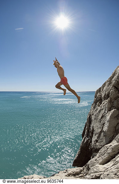 Teenager risk danger ocean holiday jump dive water
