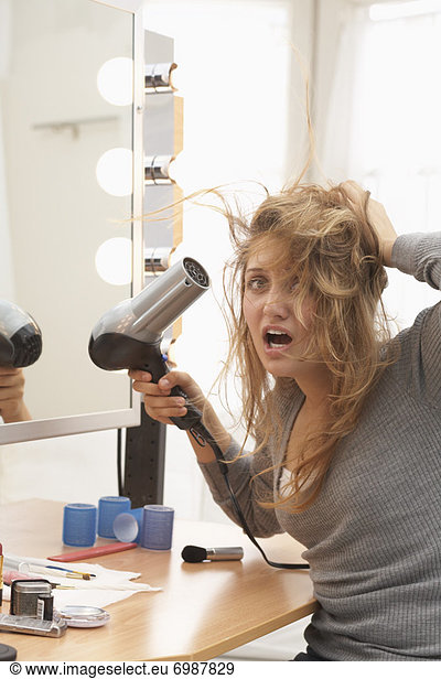 Teenager Using Hair Dryer
