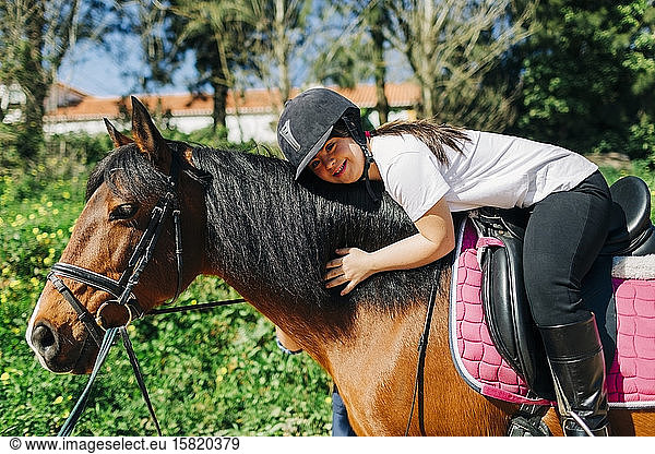 Teenager with down syndrome riding a horse