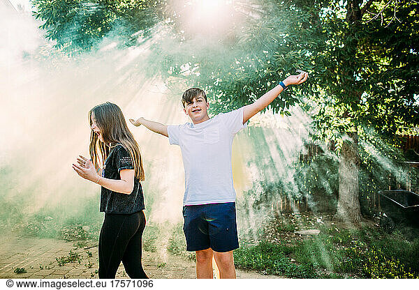 Teenagers playing in smoke bomb on sunny day