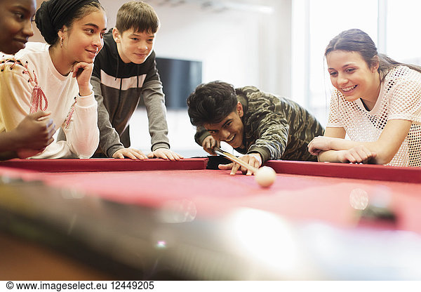 Teenagers playing pool
