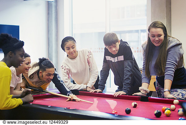 Teenagers playing pool