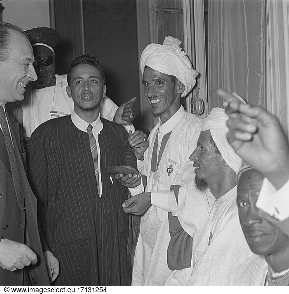 Teitgen  Pierre-Henri; French lawyer and politician (several ministers  leading to the European Convention on Human Rights); Rennes 29.5.1908 – Paris 6.4.1997. / During a reception of high-ranking personalities from the African regions by the French President René Coty in his office  the Élysée Palace  in Paris on 13 July 1955: The Secretary (Politics) for the Overseas Territories  Pierre-Henri Teitgen  in conversation with the guests. Photo.