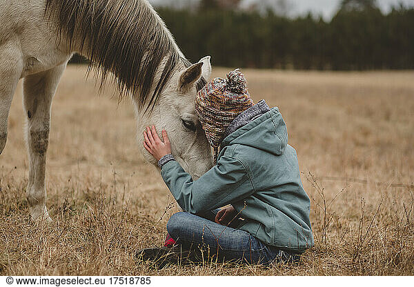 Tender touch of a horse and teen girl
