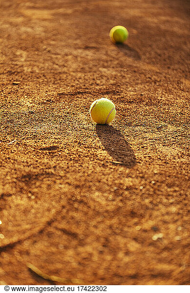 Tennis balls at sports court during sunny day