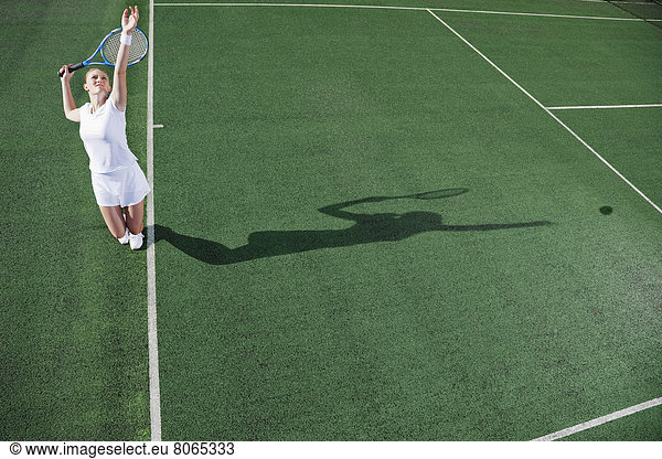 Tennisspieler serviert Ball auf dem Platz