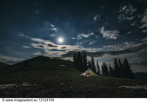 Tent on field against sky at Rocky Mountains National Park