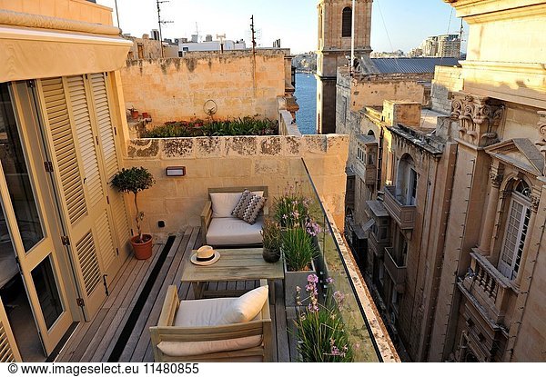 Terrace of Casa Ellul Hotel in front of the Our Lady of Mount Carmel Church and St. Paul's Anglican Pro-Cathedral  Old Theatre Street  Valletta  Malta  Southern Europe.