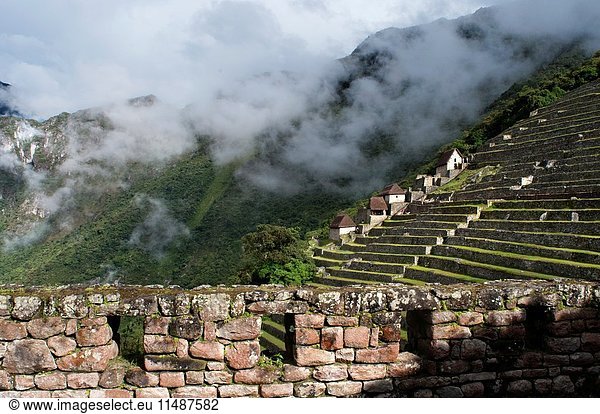 Terraces inside the archaeological complex of Machu Picchu. Machu Picchu is a city located high in the Andes Mountains in modern Peru. It lies 43 miles northwest of Cuzco at the top of a ridge  hiding it from the Urabamba gorge below. The ridge is between a block of highland and the massive Huaynac Picchu  around which the Urubamba River takes a sharp bend. The surrounding area is covered in dense bush  some of it covering Pre-Colombian cultivation terraces. Machu Picchu stands 2 430 m above sea-level  in the middle of a tropical mountain forest  in an extraordinarily beautiful setting. It was probably the most amazing urban creation of the Inca Empire at its height  its giant walls  terraces and ramps seem as if they have been cut naturally in the continuous rock escarpments. The natural setting  on the eastern slopes of the Andes  encompasses the upper Amazon basin with its rich diversity of flora and fauna. Embedded within a dramatic landscape at the meeting point between the Peruvian Andes and the Amazon Basin  the Historic Sanctuary of Machu Picchu is among the greatest artistic  architectural and land use achievements anywhere and the most significant tangible legacy of the Inca civilization. Recognized for outstanding cultural and natural values  the mixed World Heritage property covers 32 592 hectares of mountain slopes  peaks and valleys surrounding its heart  the spectacular archaeological monument of â. œLa Ciudadelaâ.(the Citadel) at more than 2 400 meters above sea level. Built in the fifteenth century Machu Picchu was abandoned when the Inca Empire was conquered by the Spaniards in the sixteenth century. It was not until 1911 that the archaeological complex was made known to the outside world.