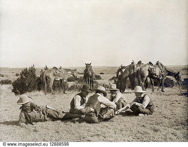 TEXAS: COWBOYS  c1906. Several cowboys seated on the ground while playing a game of mumblety peg during a work break at the Turkey Track Ranch in Texas. Photograph by Erwin Evans Smith  c1906.