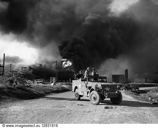 TEXAS: EXPLOSION 1947. U.S. Army troops guarding an area of a burning oil field in Texas City Texas caused by an explosion. Photograph April 1947.