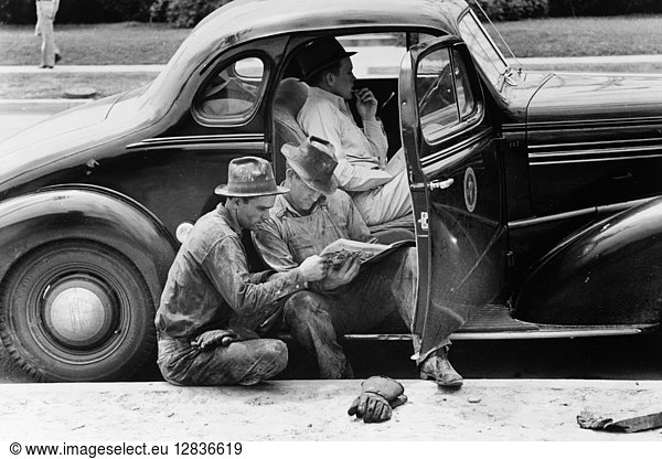 TEXAS: OIL WORKERS  1939. Oil field workers reading the newspaper during a break at Kilgore  Texas. Photograph by Russell Lee  April 1939.