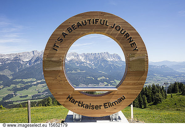 Text on circular shape wood against Kaiser Mountains  Tyrol  Austria