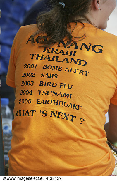 THA Thailand Bangkok woman wearing a shirt with a listing of catastrophes of the last 5 years in Thailand. |