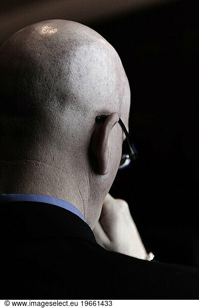 The back of bald man's head.