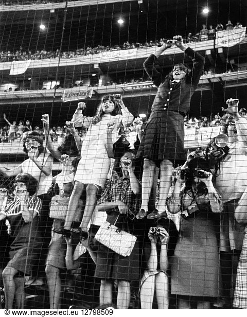 THE BEATLES  1965. Fans climbing a fence at The Beatles concert at Shea Stadium in New York City. Photograph  15 August 1965.