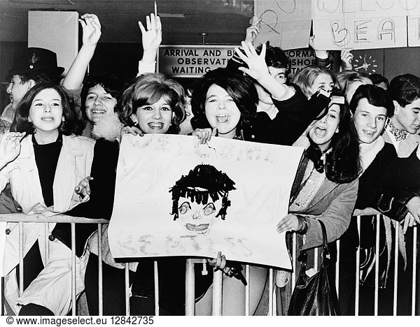THE BEATLES  1964. Screaming fans greeting the Beatles upon their arrival at John F. Kennedy Airport in New York City. Photograph  7 February 1964.