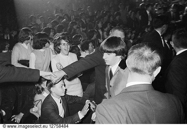 THE BEATLES  1964. Security guards guiding Ringo Starr to the stage for the Beatles concert at the Washington Coliseum in Washington  D.C. Photographed by Marion Trikosko  11 February 1964.