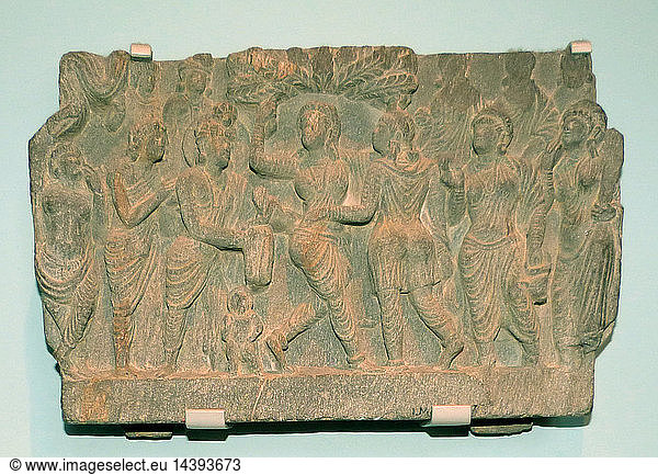 The birth of the Buddha. AD1-200 Ancient Gandhara Pakistan  Schist. The Buddha"s mother Queen Maya stands beneath a shala tree  with the future Buddha emerging from her side. The god Indra receives the infant.