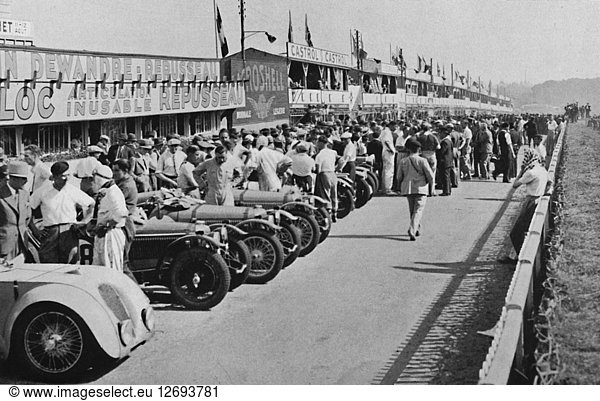 The busy pits: before the start of Le Mans 24-hour Race  1937. Artist: Unknown.