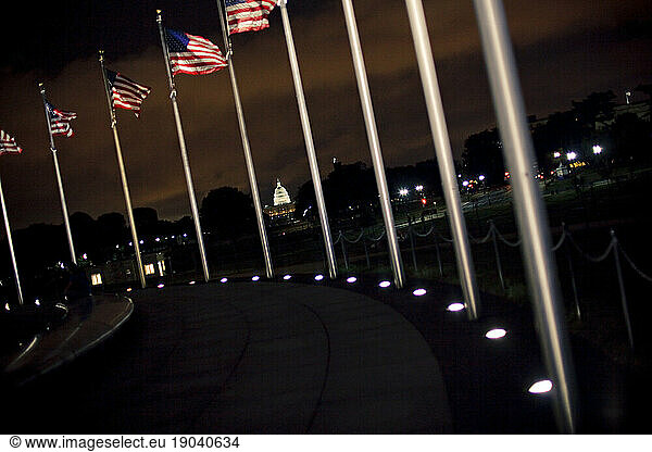 The Capitol building in between flag poles.