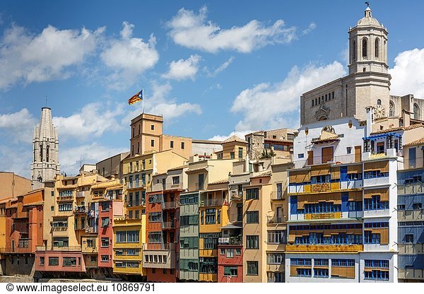 The cathedral and Sant Felix church behind skyline of Girona Town. Catalan independetist flag and houses of the old quarter