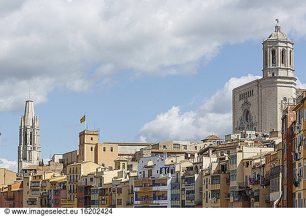 The cathedral and Sant Felix church behind skyline of Girona Town. Catalan independetist flag and houses of the old quarter