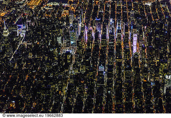 The city of New York City  Manhattan  aerial view at night.