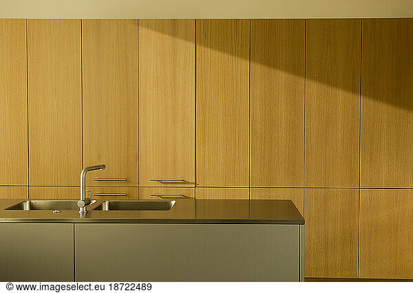 The clean lines of a modern kitchen in early morning light.