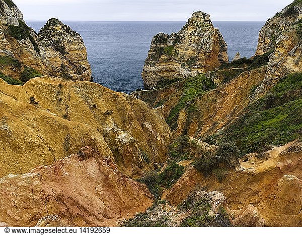The cliffs and sea stacks of Ponta da Piedade at the rocky coast of the Algarve in Portugal. Europe  Southern Europe  Portugal  March
