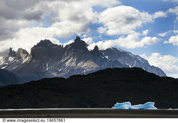 The Cuernos del Paine protrude into the clouds.