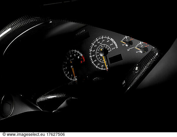 The dash dashboard instruments and display a speedometer odometer of a sports car.
