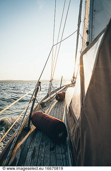 The deck of a sailboat sailing in Maine during late day