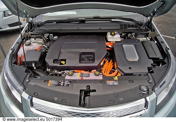 The engine compartment of a Chevrolet Volt hybrid gas/electric car Right side: the power inverter in top of the electric motor Left side: the 1 4-liter gasoline-powered engine used as generator to provide power to the electric motor or to engage mechani. The engine compartment of a Chevrolet Volt hybrid gas/electric car Right side: the power inverter in top of the electric motor Left side: the 1 4-liter gasoline-powered engine used as generator to provide power to the electric motor or to engage mechanically to assist propulsion when the battery is depleted It is the most fuel-efficient car with an internal combustion engine sold in the United States and can travel 25 to 50 miles on a lithium-ion battery with a total range of 379 miles Overall fuel economy is 60 miles per gallon