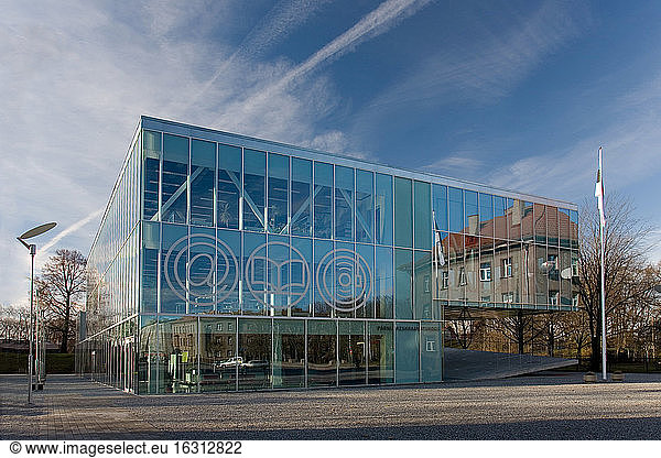 The exterior glass walls of a modern library building  internet icons etched on glass