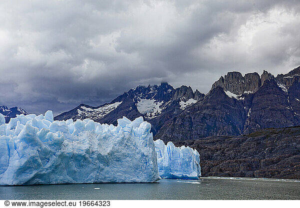 The famous Glacier Grey in Torres del Paine National park as seen beneath grey skies and a with a backdrop of impressive peaks.