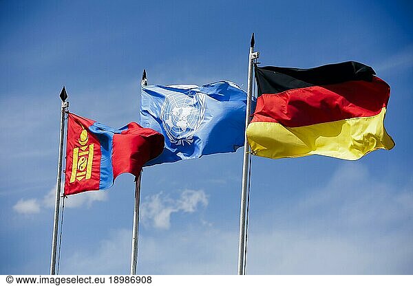 The flags of Germany  the United Nations (UN) and Germany fly in the wind near the Nalaikh barracks. Nalaikh  30.06.2023.  Nalaikh  Mongolia  Asia
