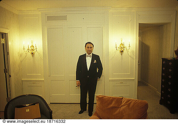 The former chairman of a large financial company poses for a portrait in black tie attire in his swanky Connecticut home.