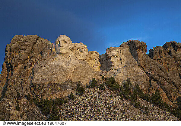 The granite faces of Mount Rushmore National Memorial at sunrise in South Dakota  USA